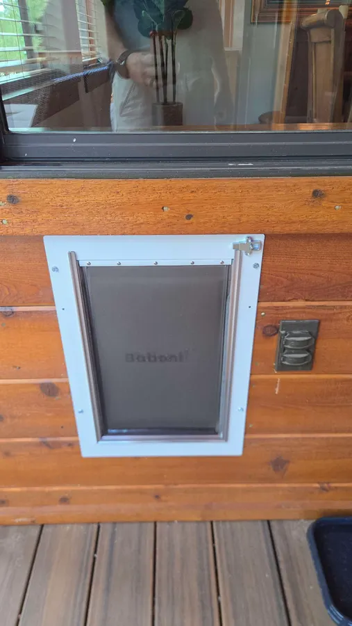 Pet door installed in a cedar wall, White Mountains, AZ