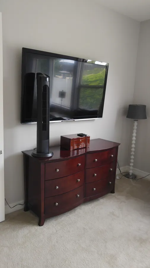 TV mounted above a dresser with soundbar, White Mountains, AZ