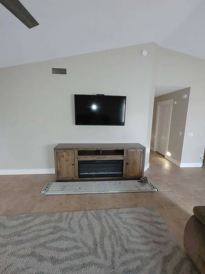 TV mounted above an electric fireplace console, White Mountains, AZ