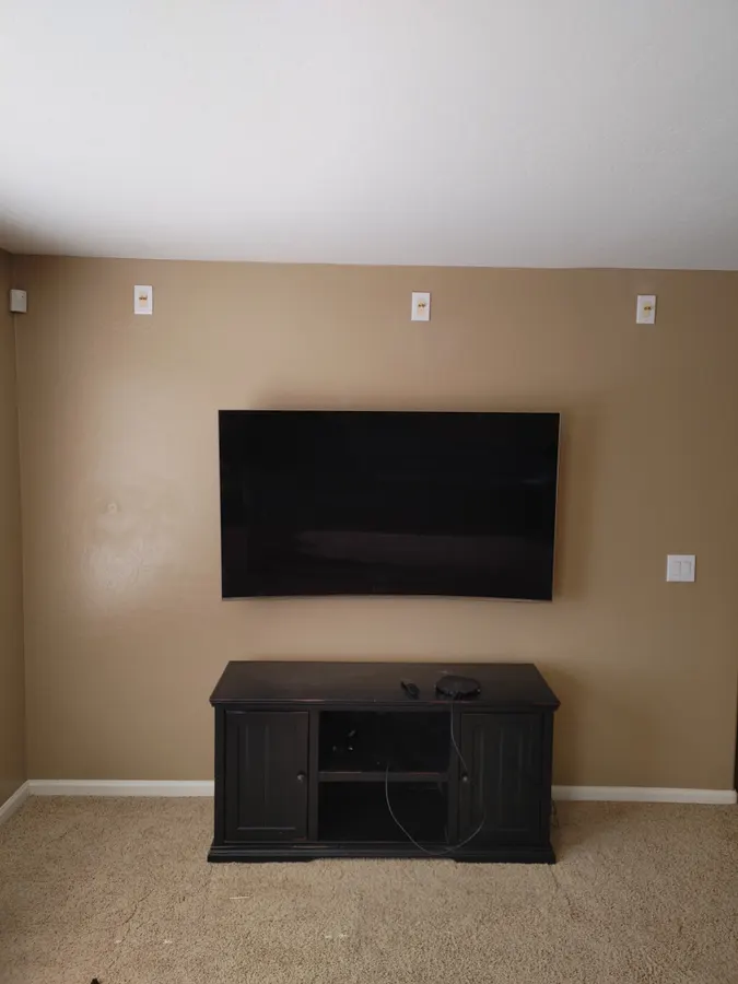 TV mounted on a tan wall above a console, White Mountains, AZ